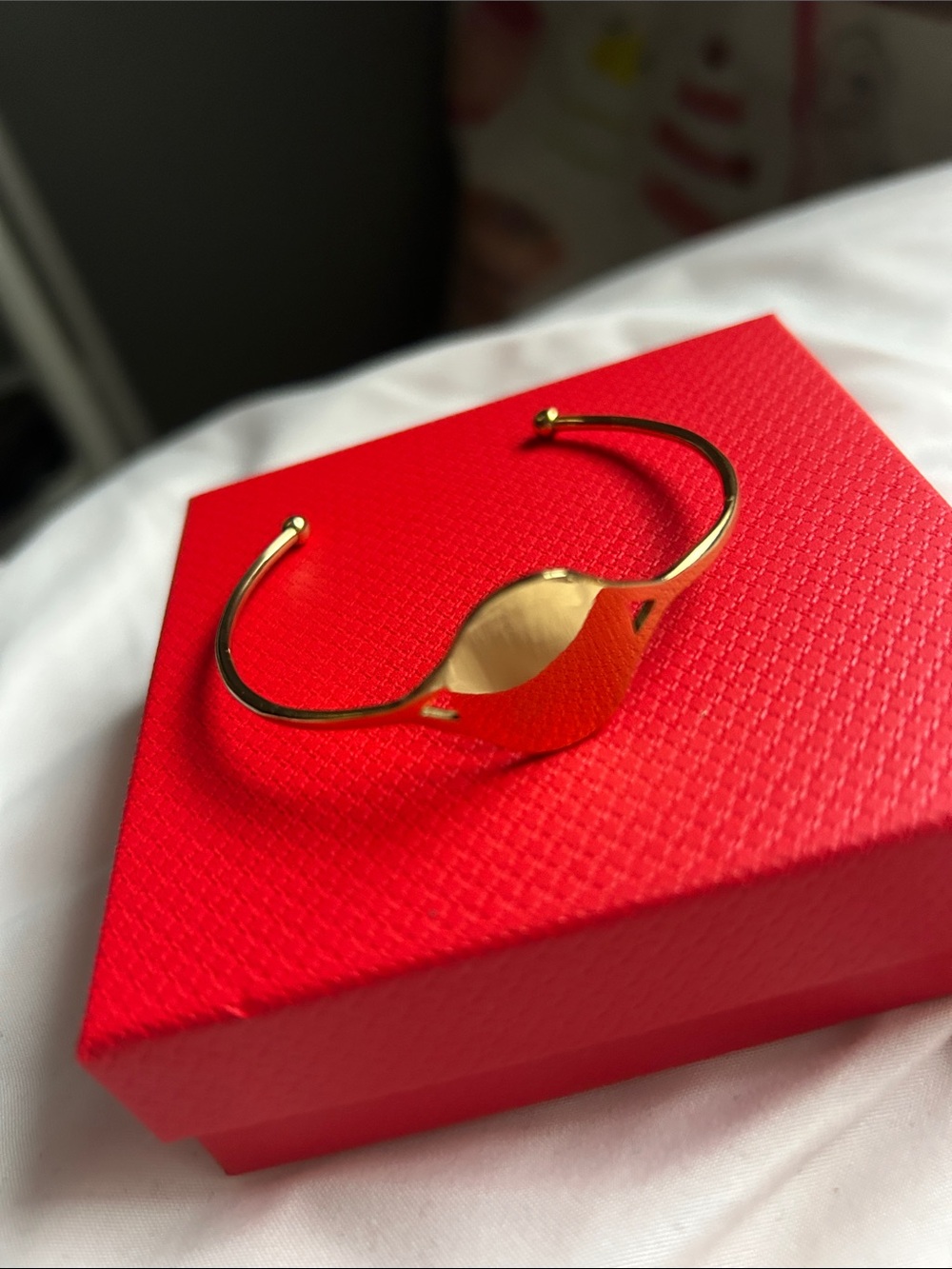 Plunder Gold Tone Signet Cuff Bracelet on Red Accent